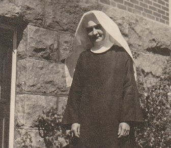 Photo of Sister Annella Zervas, OSB, standing outside a building.